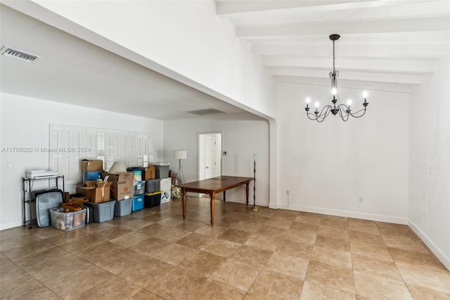 dining space featuring beamed ceiling and a chandelier