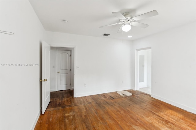 unfurnished room featuring ceiling fan and dark hardwood / wood-style flooring