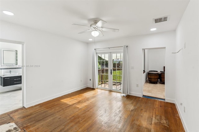 unfurnished room with french doors, ceiling fan, and hardwood / wood-style floors