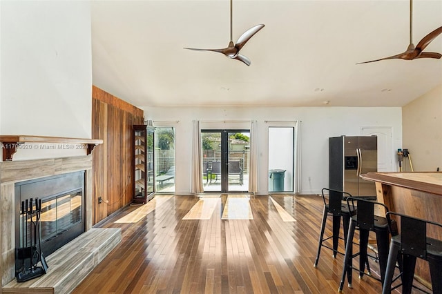 living room with ceiling fan, wood-type flooring, and french doors