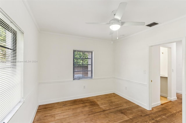 spare room featuring hardwood / wood-style flooring, ceiling fan, and crown molding