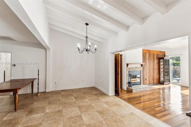 dining room featuring beamed ceiling and a chandelier