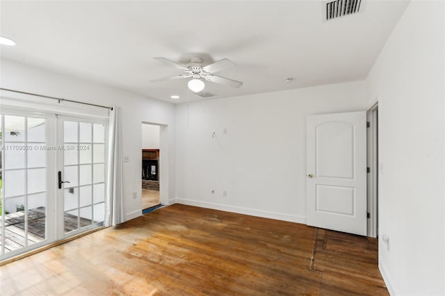 unfurnished room featuring french doors, ceiling fan, and wood-type flooring