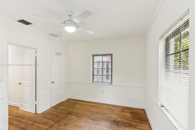 unfurnished room featuring wood-type flooring, ceiling fan, and crown molding