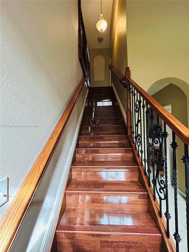 stairs featuring hardwood / wood-style flooring