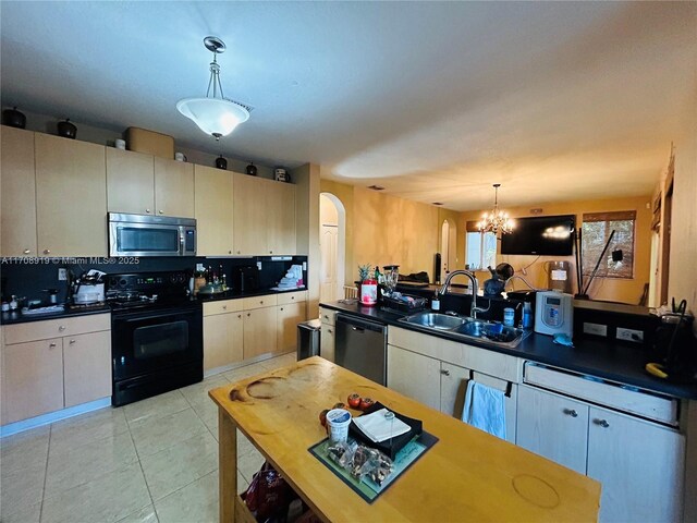 kitchen with dark countertops, stainless steel microwave, dishwasher, black / electric stove, and a sink