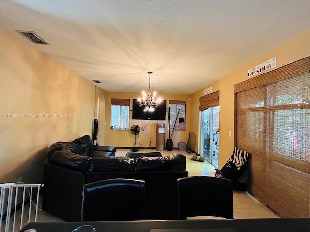 living room featuring visible vents and a chandelier