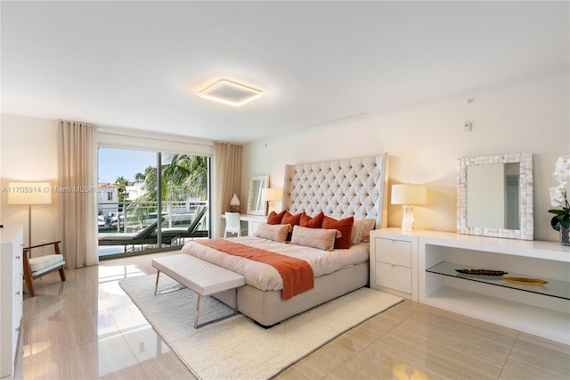 bedroom with access to exterior and light tile patterned floors