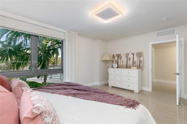 bedroom with light tile patterned floors