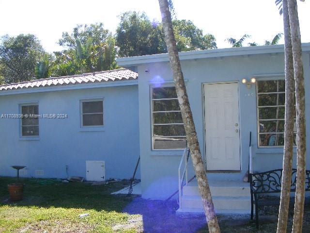 rear view of property featuring a yard