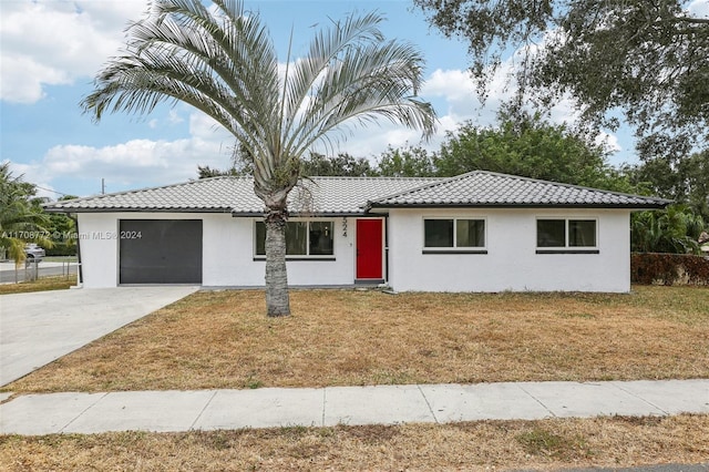 view of front of property featuring a garage and a front lawn