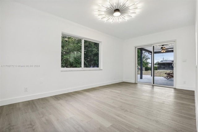 empty room with ceiling fan and hardwood / wood-style floors