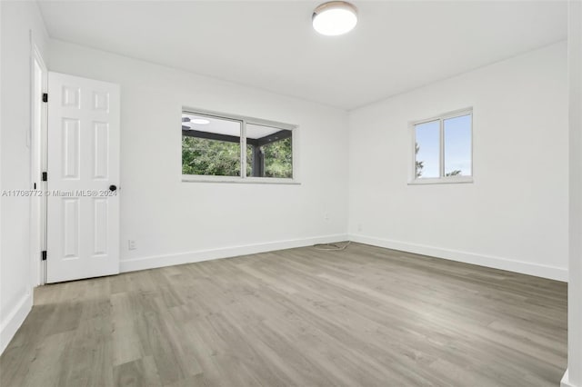 spare room with plenty of natural light and light wood-type flooring