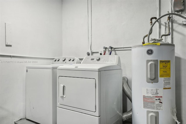 laundry area featuring electric water heater and separate washer and dryer