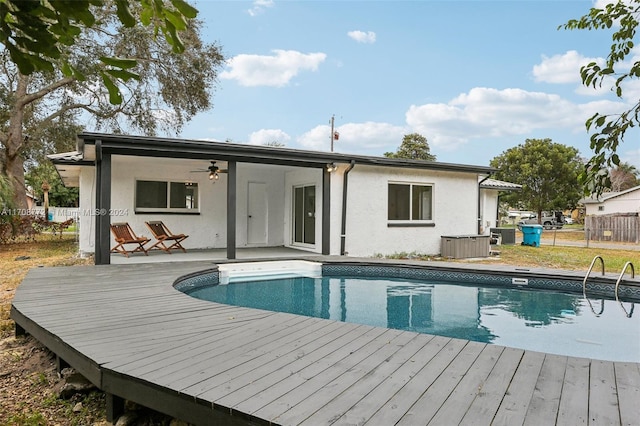 back of house featuring ceiling fan and a swimming pool side deck