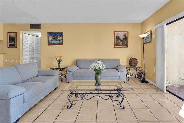 tiled living room with a textured ceiling