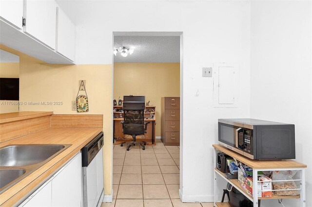 kitchen with white cabinetry, dishwasher, electric panel, a textured ceiling, and light tile patterned floors