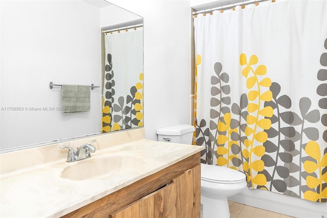 bathroom featuring toilet, vanity, and tile patterned floors