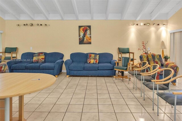 tiled living room featuring beamed ceiling