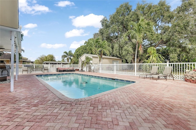 view of swimming pool featuring a fenced in pool, fence, and a patio