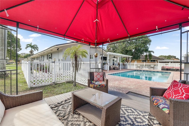 view of swimming pool with a patio area, a fenced backyard, an outdoor hangout area, and a fenced in pool