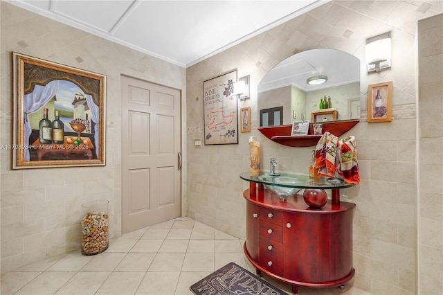 entryway featuring light tile patterned floors and tile walls