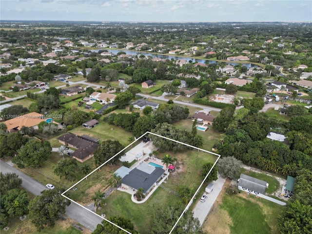 birds eye view of property featuring a water view and a residential view