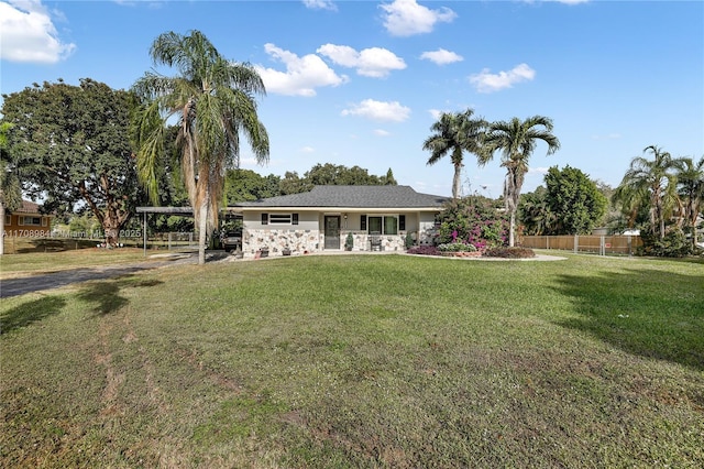 single story home featuring fence, a carport, and a front yard