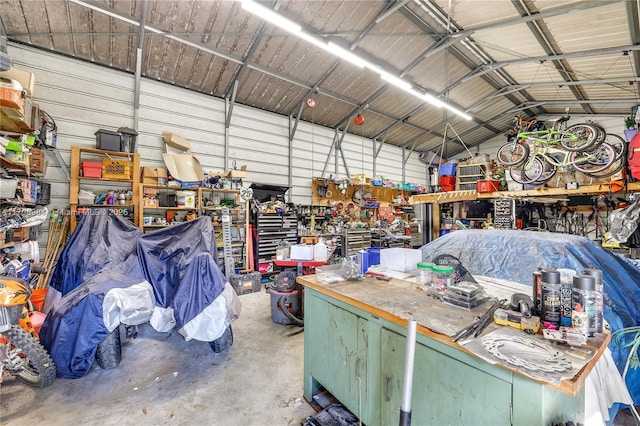 garage with a workshop area and metal wall