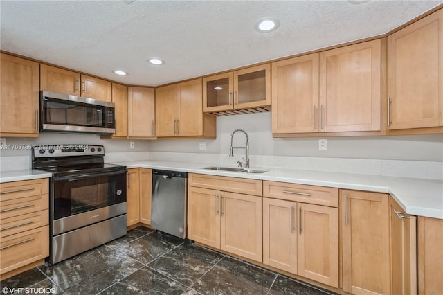 kitchen featuring a textured ceiling, sink, and stainless steel appliances