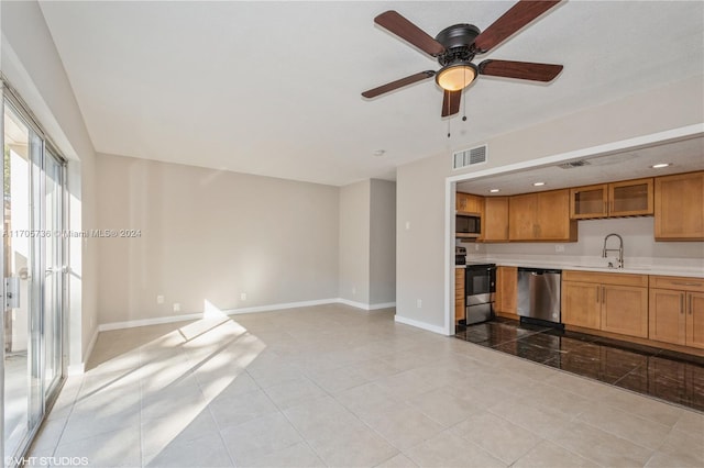 kitchen featuring light tile patterned flooring, appliances with stainless steel finishes, ceiling fan, and sink