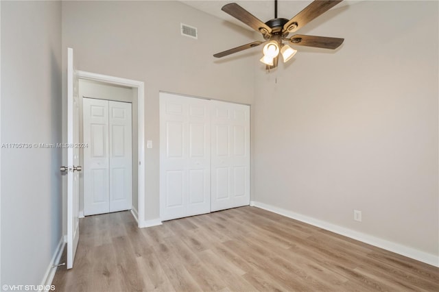 unfurnished bedroom featuring a closet, light hardwood / wood-style flooring, and ceiling fan