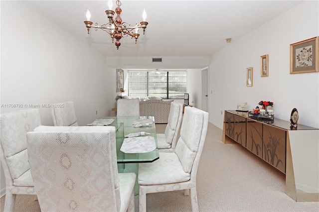 dining room with an inviting chandelier and light carpet