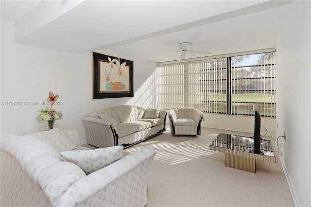 carpeted living room featuring ceiling fan