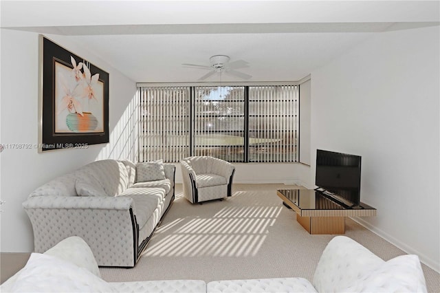 living room featuring carpet floors and ceiling fan