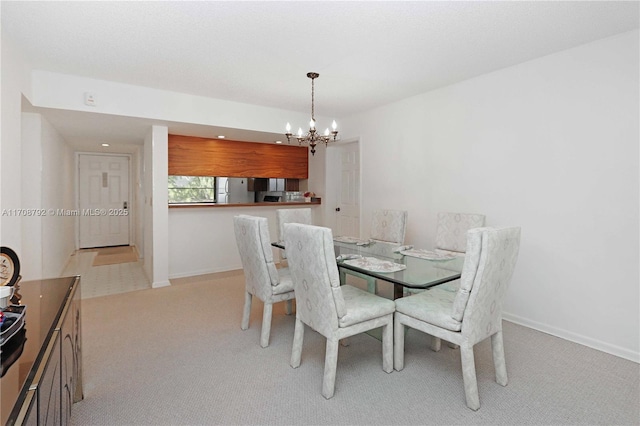 carpeted dining space featuring an inviting chandelier