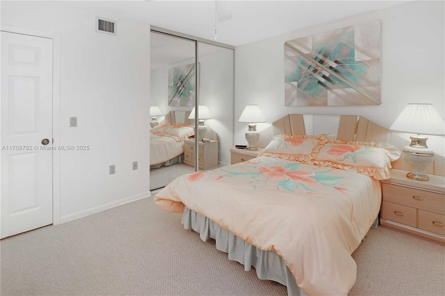 carpeted bedroom featuring ceiling fan and a closet