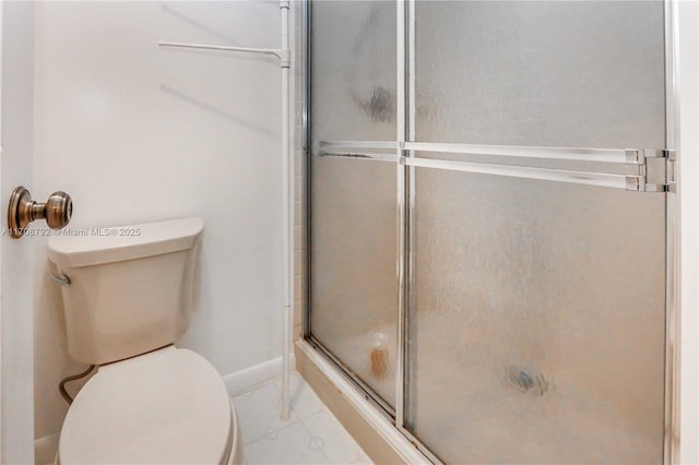 bathroom featuring walk in shower and toilet