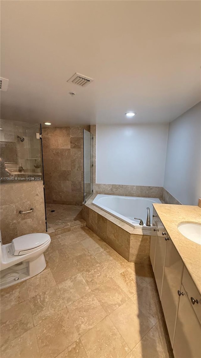 full bathroom with toilet, vanity, and separate shower and tub