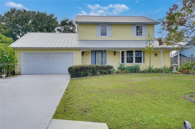 view of front facade with a front lawn and a garage