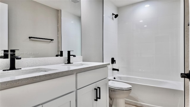 full bathroom featuring toilet, vanity, and tiled shower / bath combo