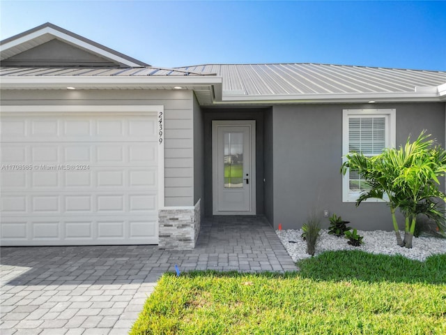 view of exterior entry with a garage