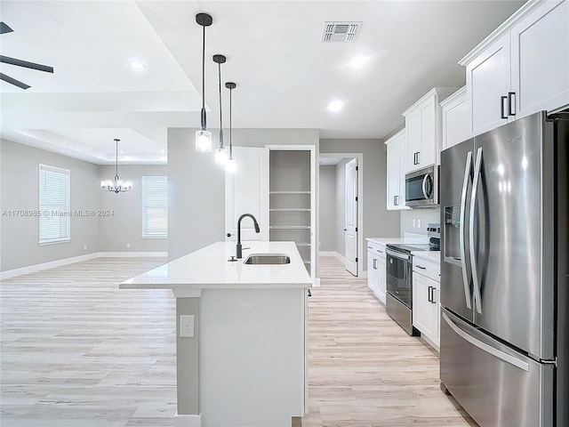 kitchen featuring white cabinetry, sink, an island with sink, appliances with stainless steel finishes, and light wood-type flooring