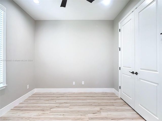 unfurnished bedroom featuring a closet, ceiling fan, and light hardwood / wood-style flooring