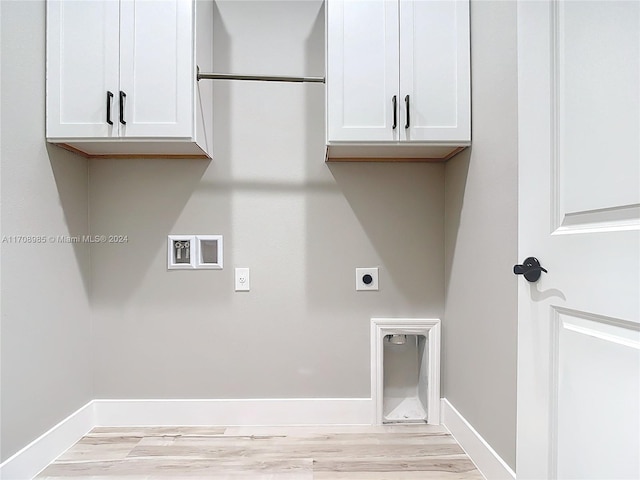 laundry room featuring hookup for an electric dryer, light wood-type flooring, and cabinets