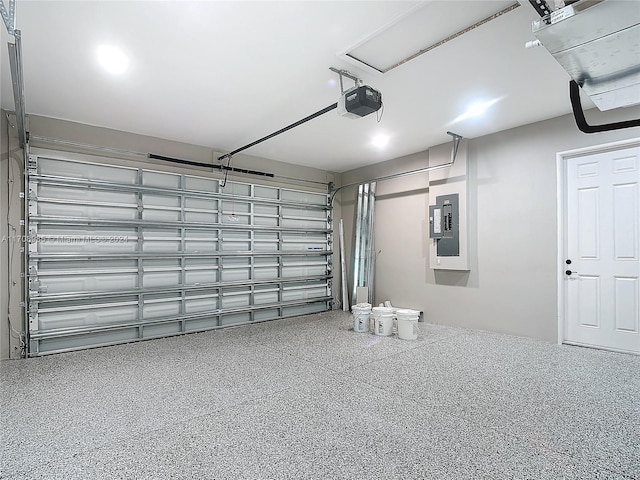 garage with a garage door opener and electric panel