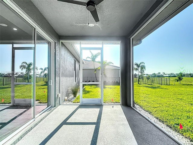 sunroom featuring ceiling fan