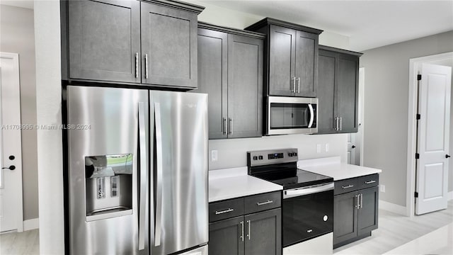 kitchen featuring light hardwood / wood-style floors and appliances with stainless steel finishes