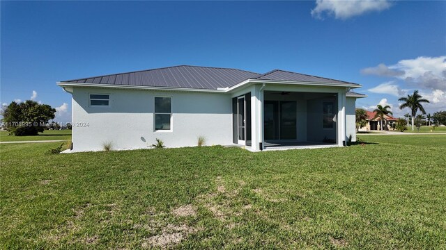 rear view of house with a lawn