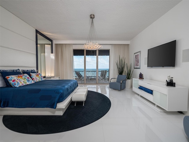 bedroom with access to exterior, expansive windows, a textured ceiling, and an inviting chandelier